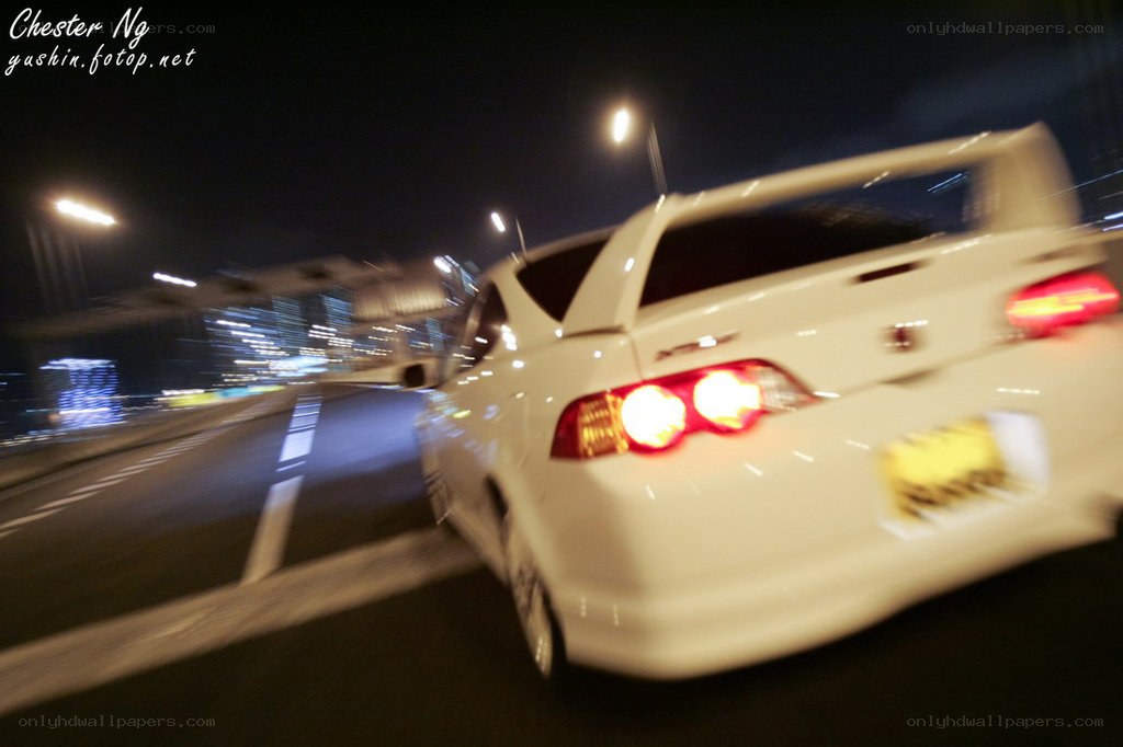White car driving at night