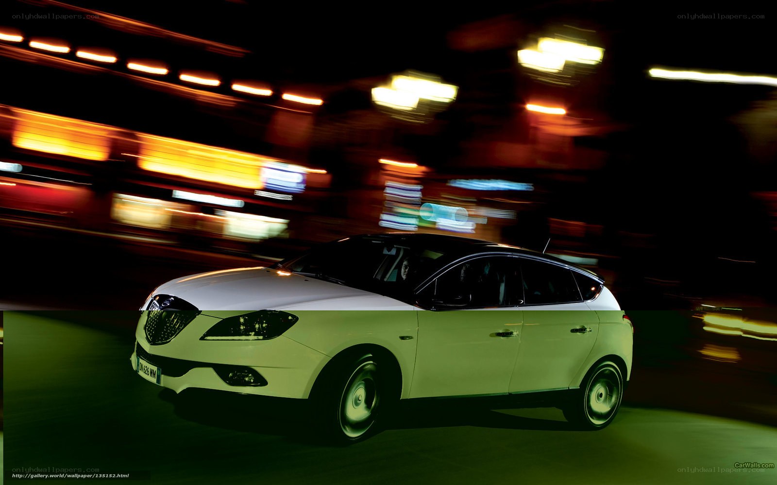 White car driving at night