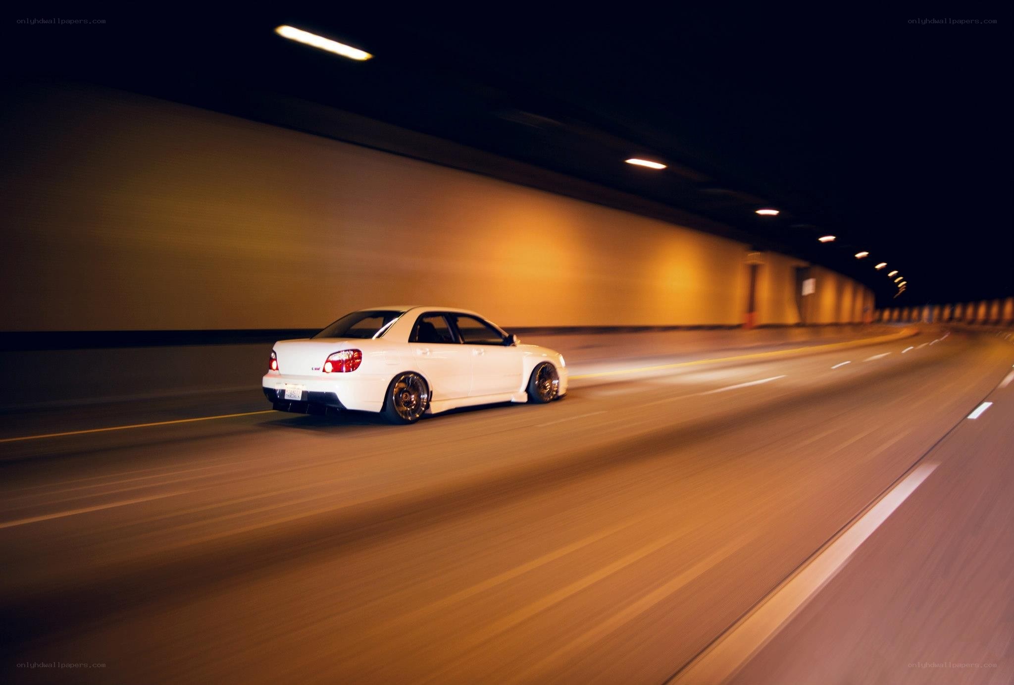 White car driving in tunnel