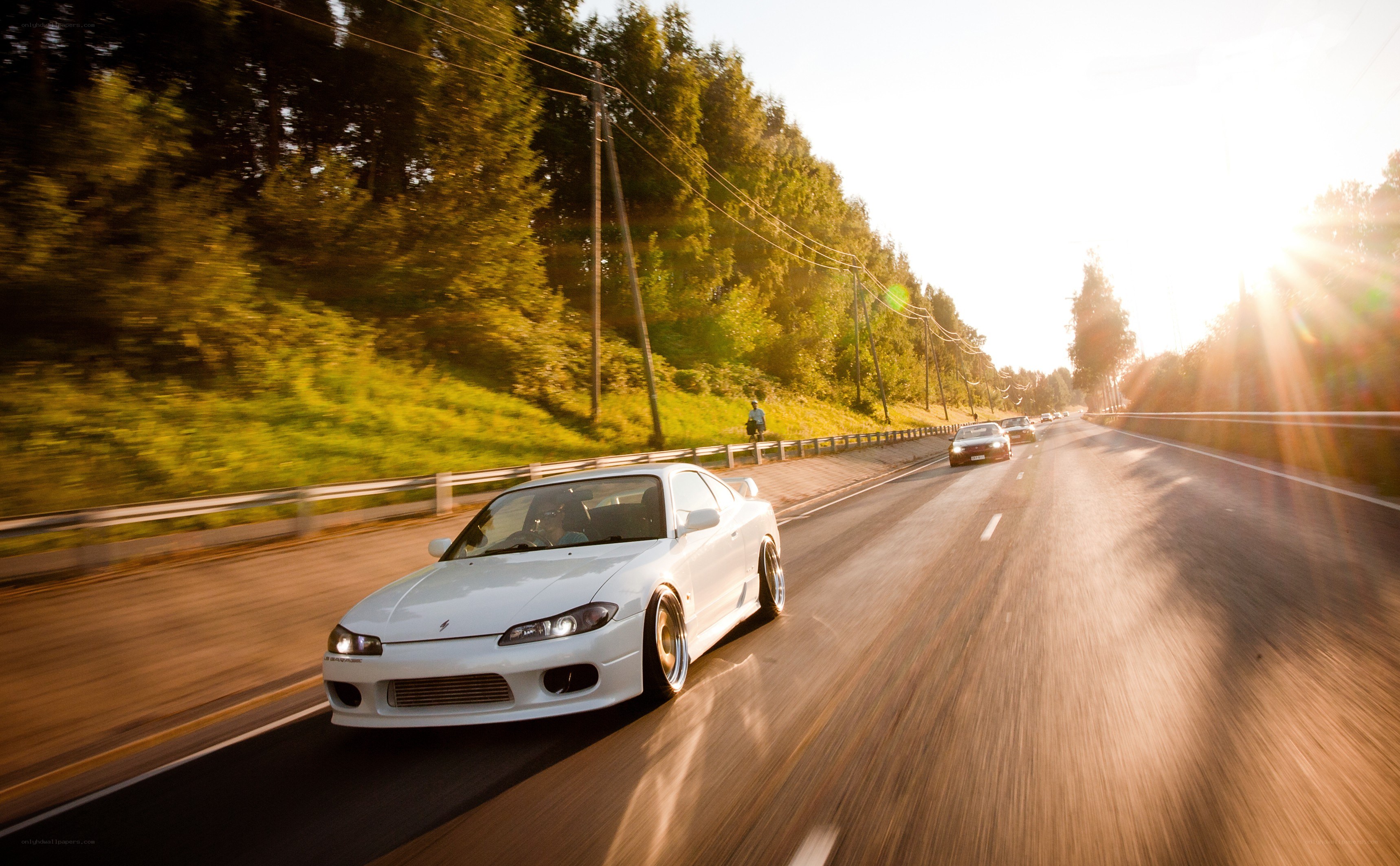 White car driving on highway