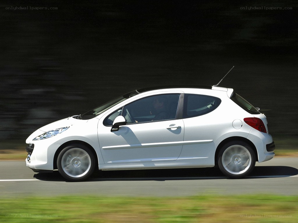 white car driving on road