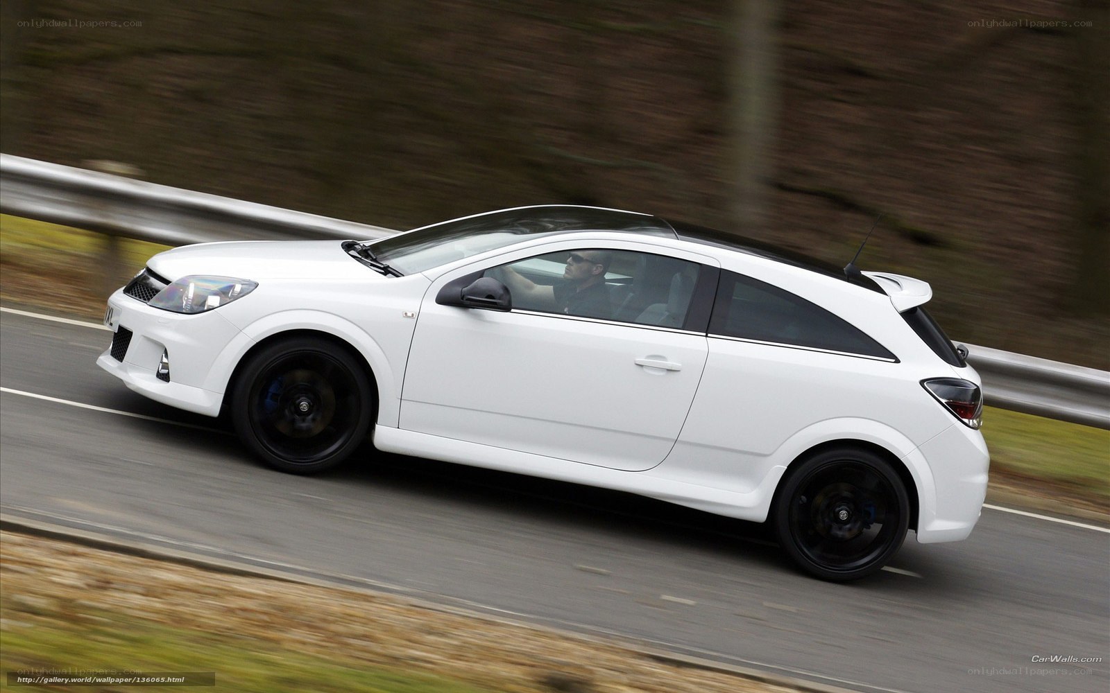 white car driving on road