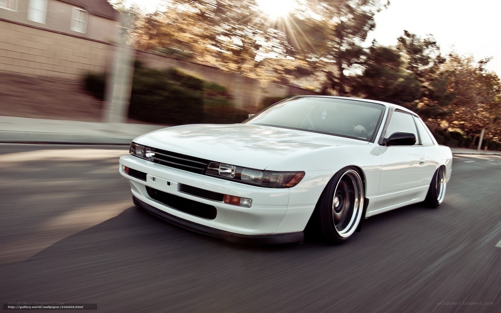 white car driving on street
