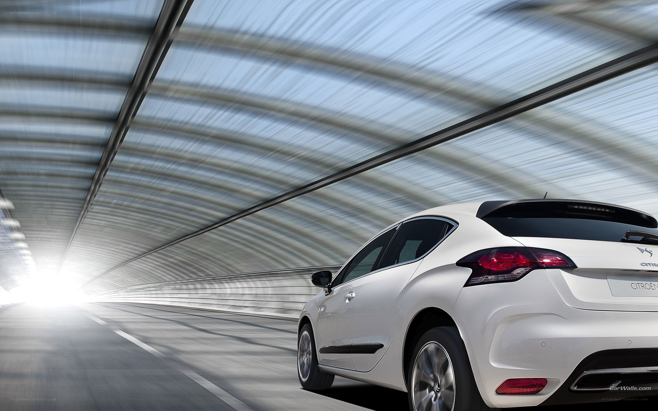 White car driving through tunnel