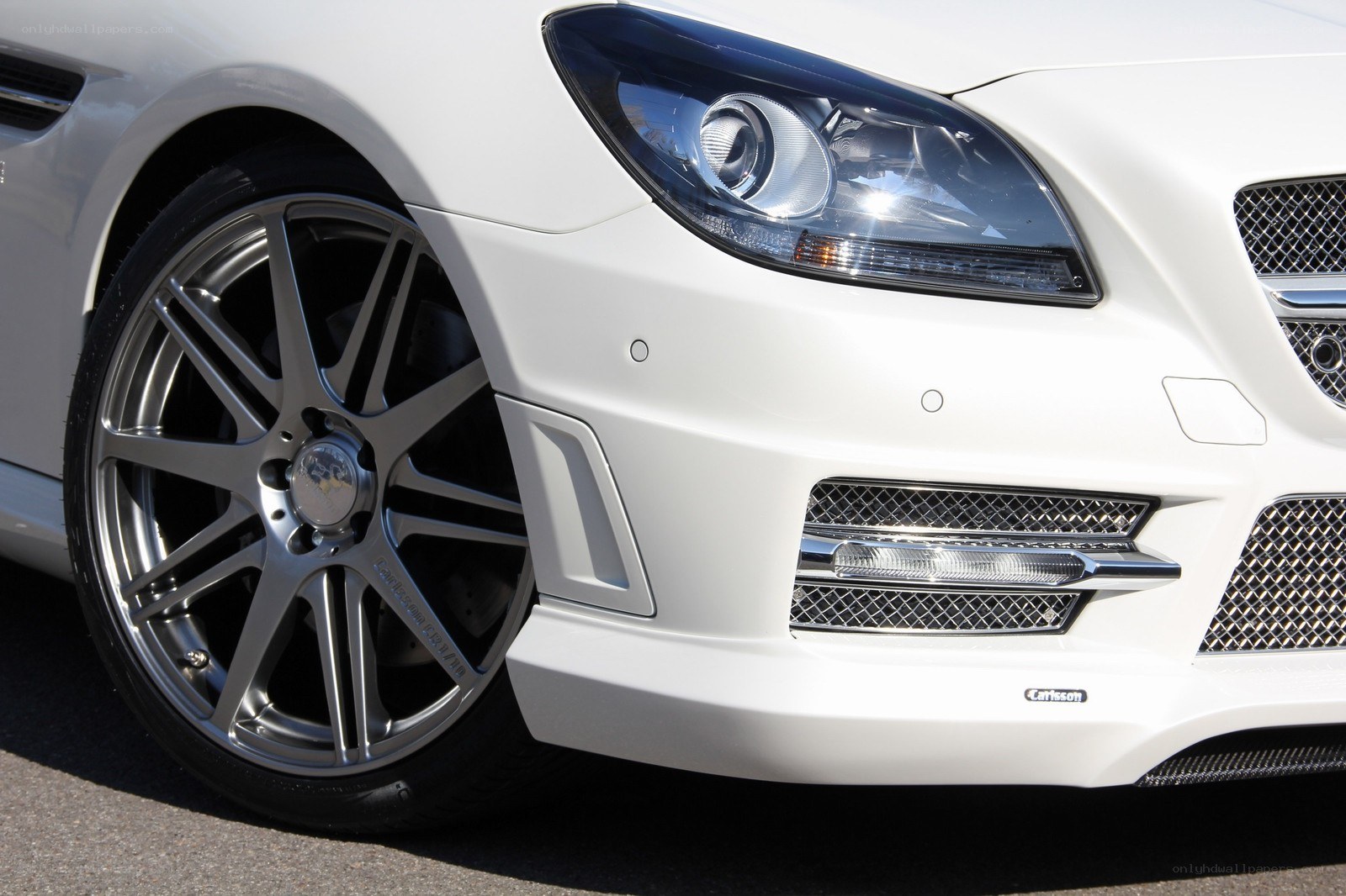 white car front wheel and headlight