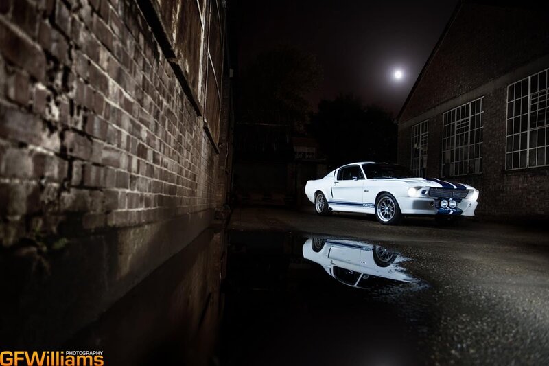 White car in alley at night