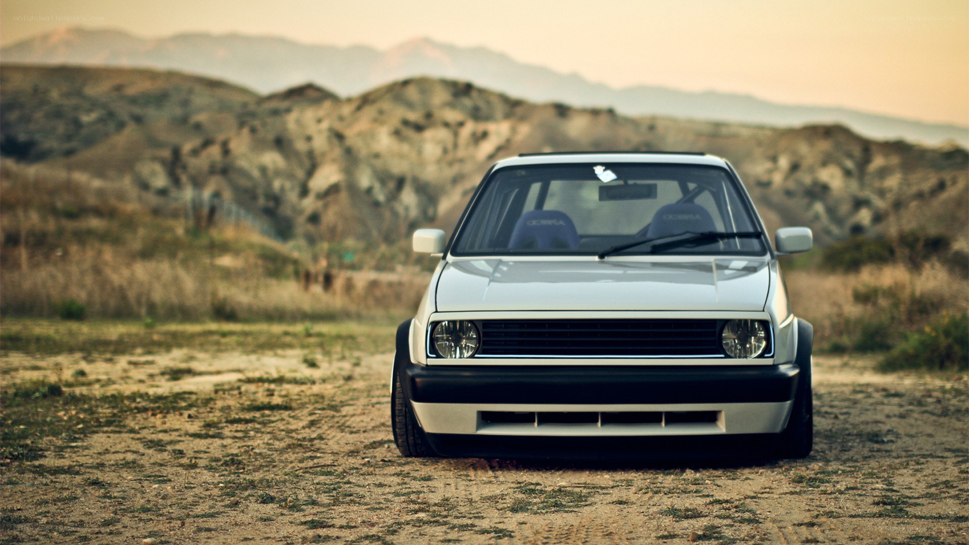 white car in desert landscape