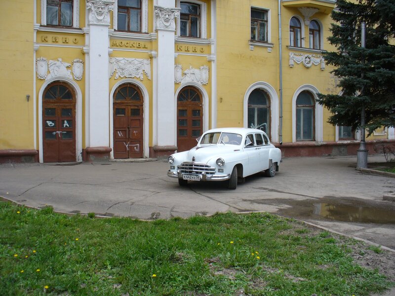 White car in front of cinema