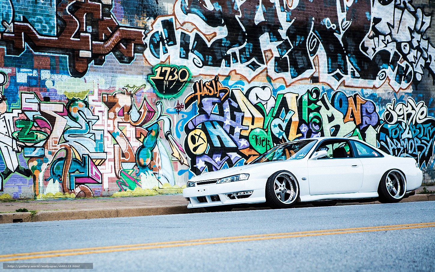 White car in front of graffiti wall