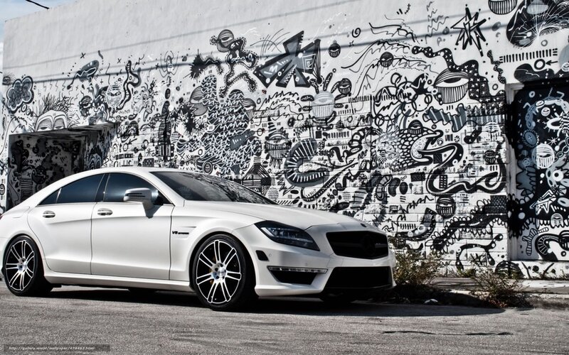 White car in front of graffiti wall