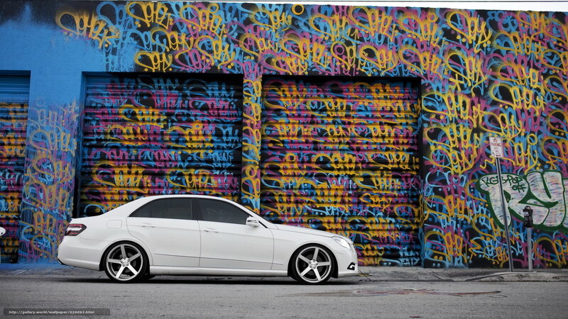White car in front of graffiti wall