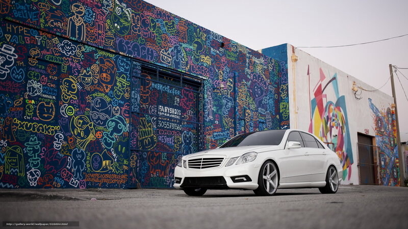 White car in front of graffiti wall