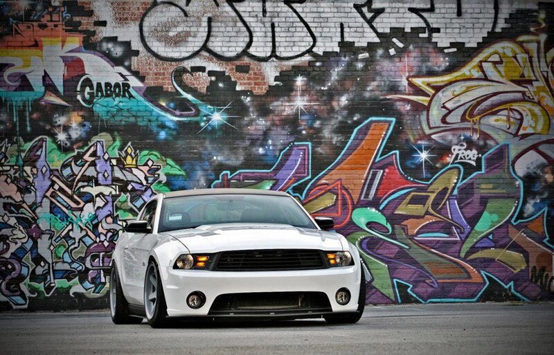 white car in front of graffiti wall