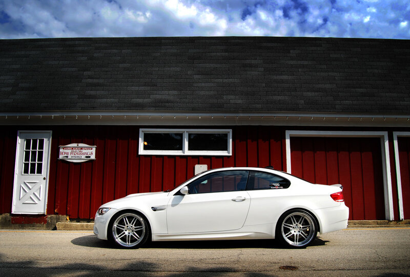white car in front of red building