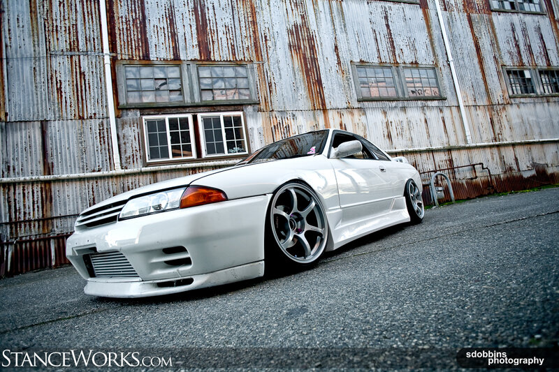 white car in front of rusty building
