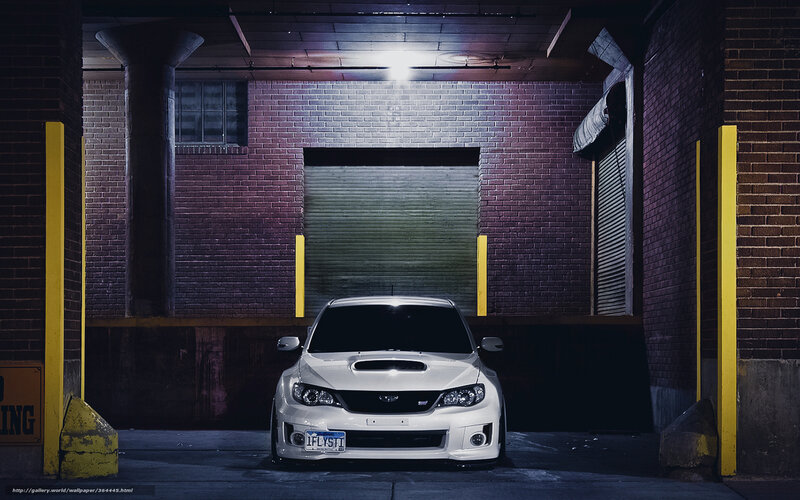 White car in garage at night