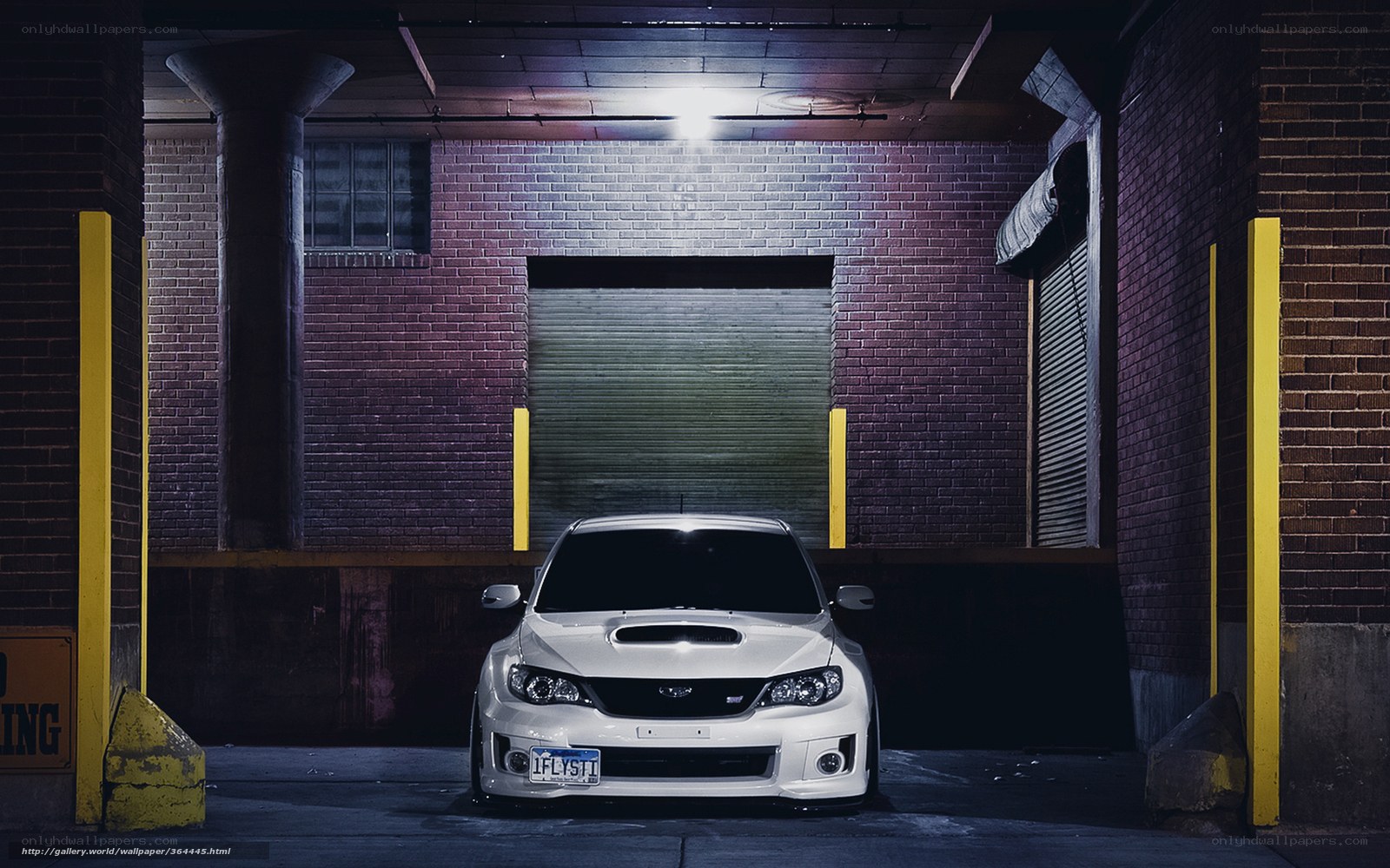 White car in garage at night