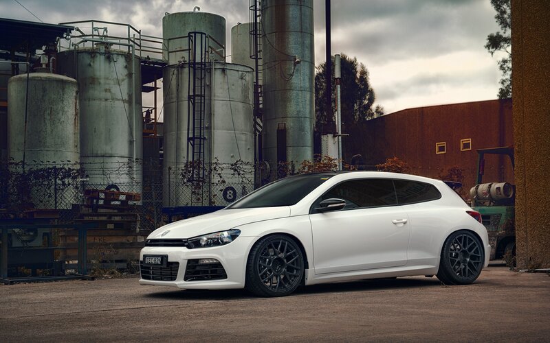 White Car in Industrial Area — Dramatic, Photograph, Industrial Tanks