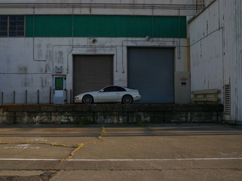 White car in industrial lot