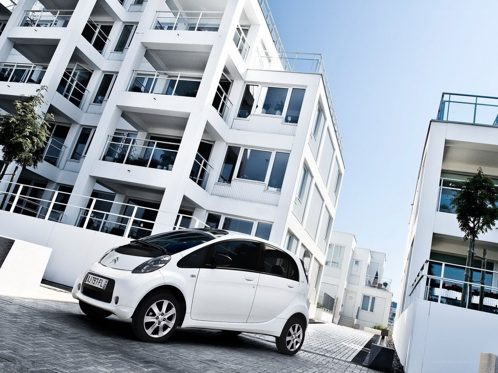 White car in modern apartment complex