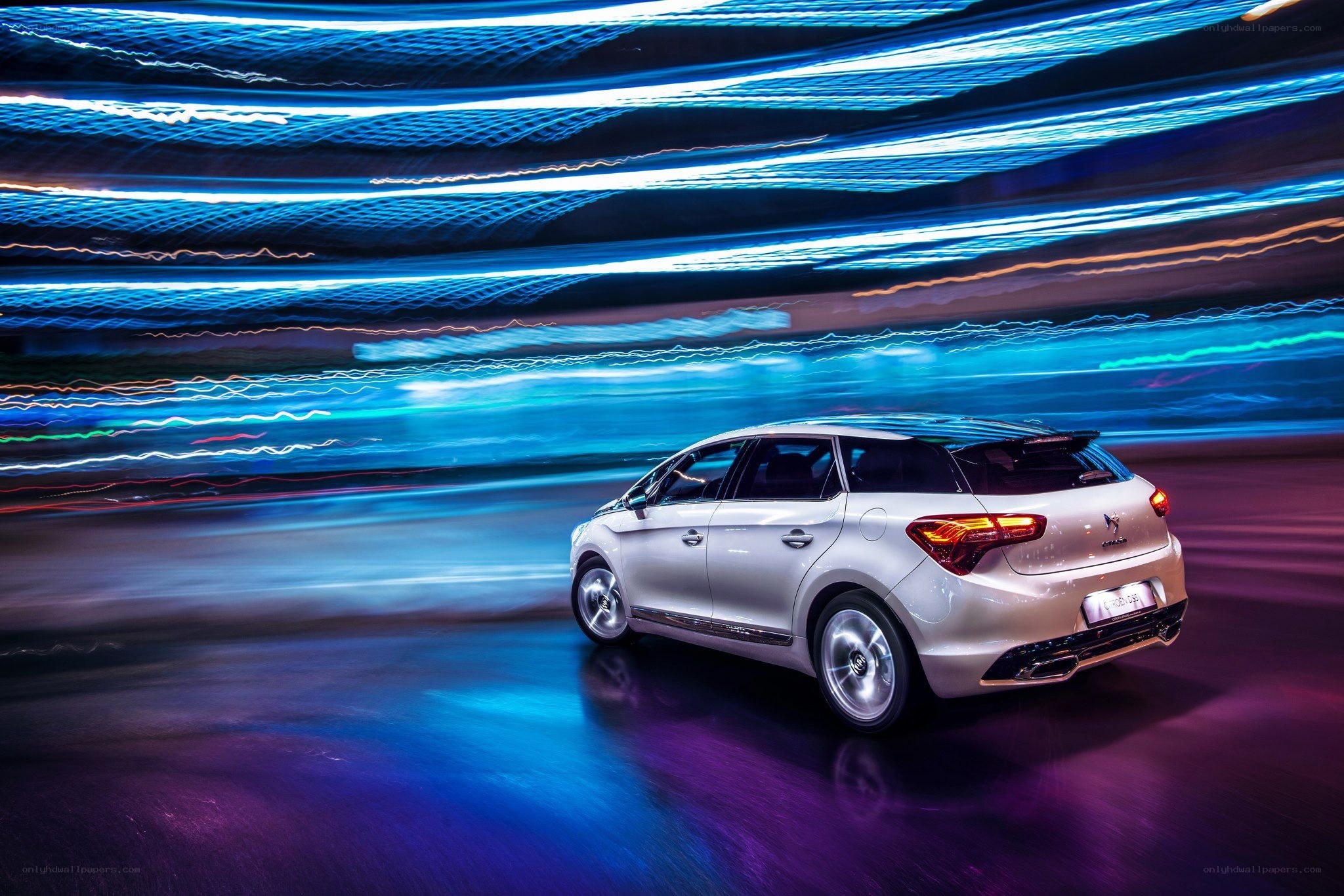 White car in motion at night