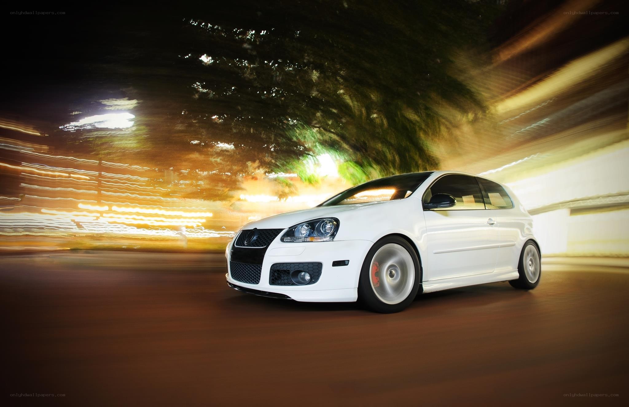 White car in motion at night