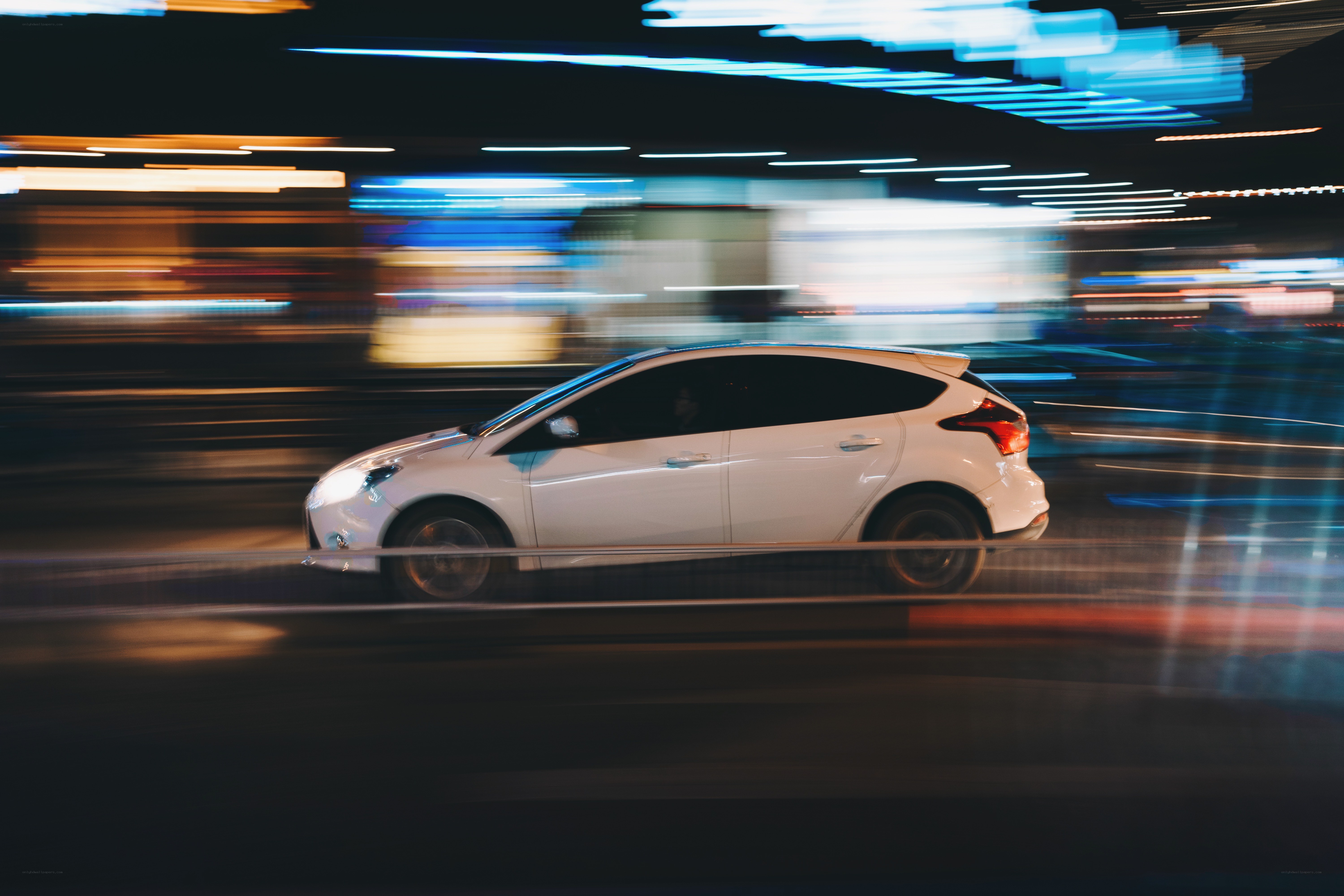 White car in motion at night