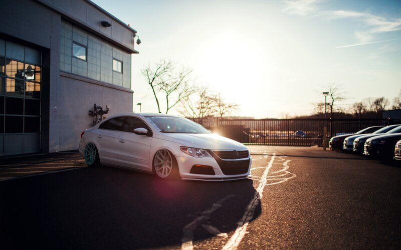 white car in parking lot at sunset