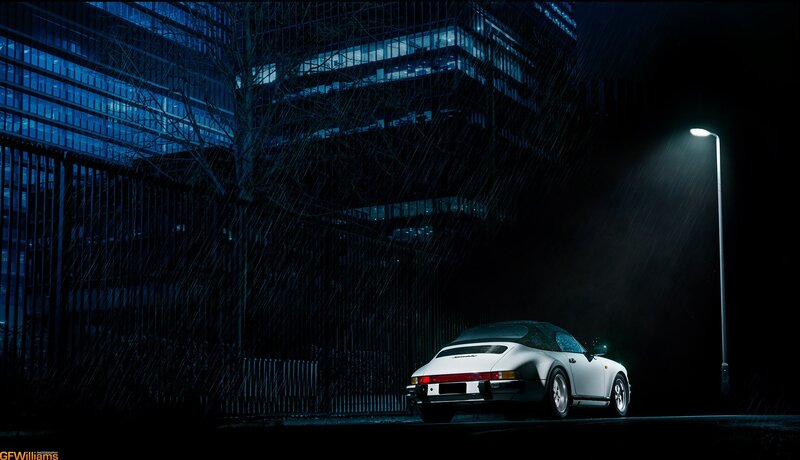 White car in rainy city