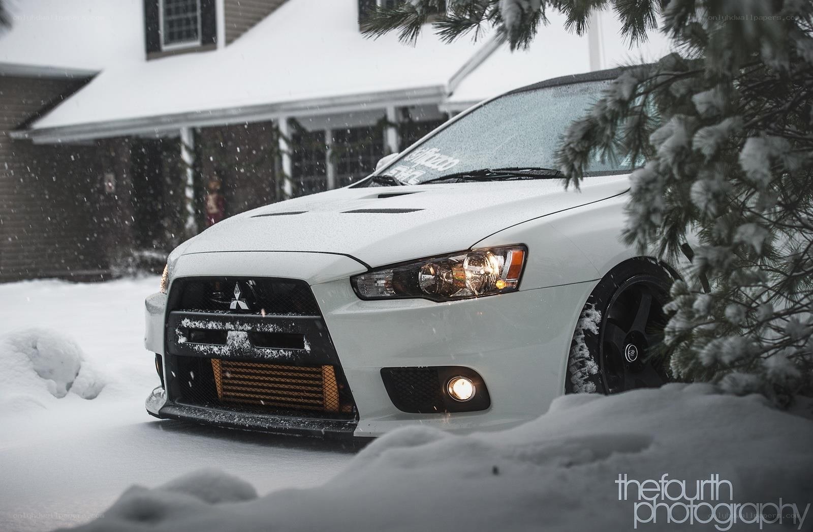 White car in snowy landscape