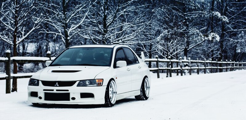 white car in snowy landscape