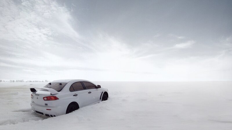 White car in snowy landscape