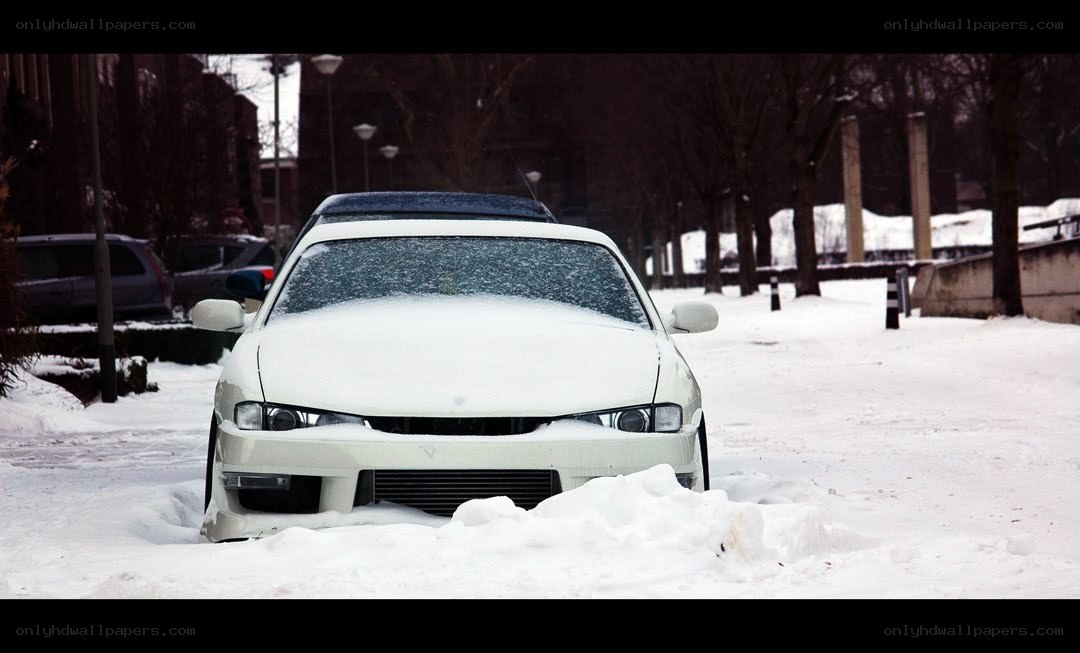 White car in snowy street
