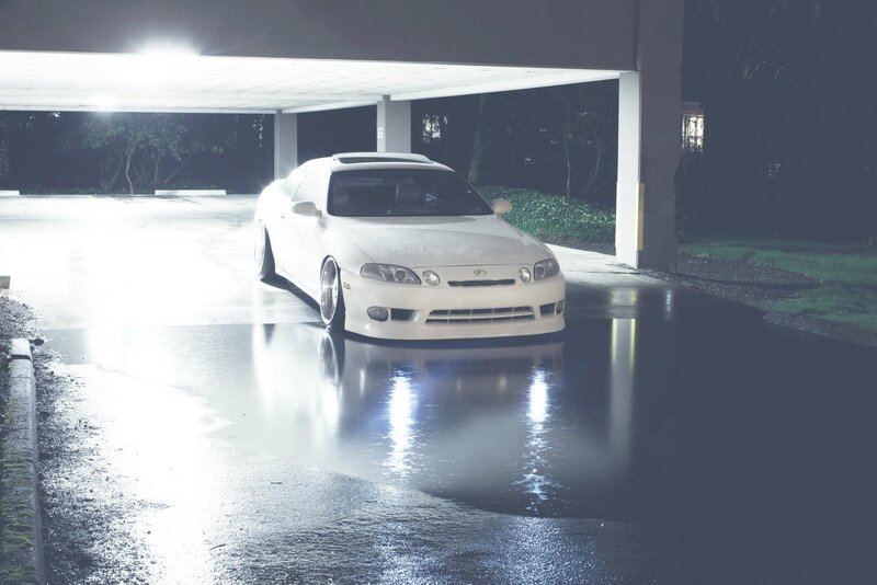 white car in wet parking garage