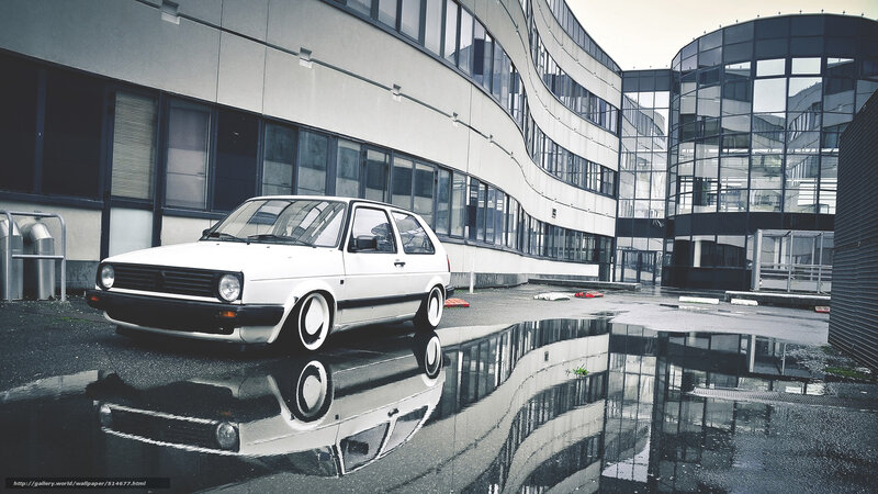 white car in wet parking lot