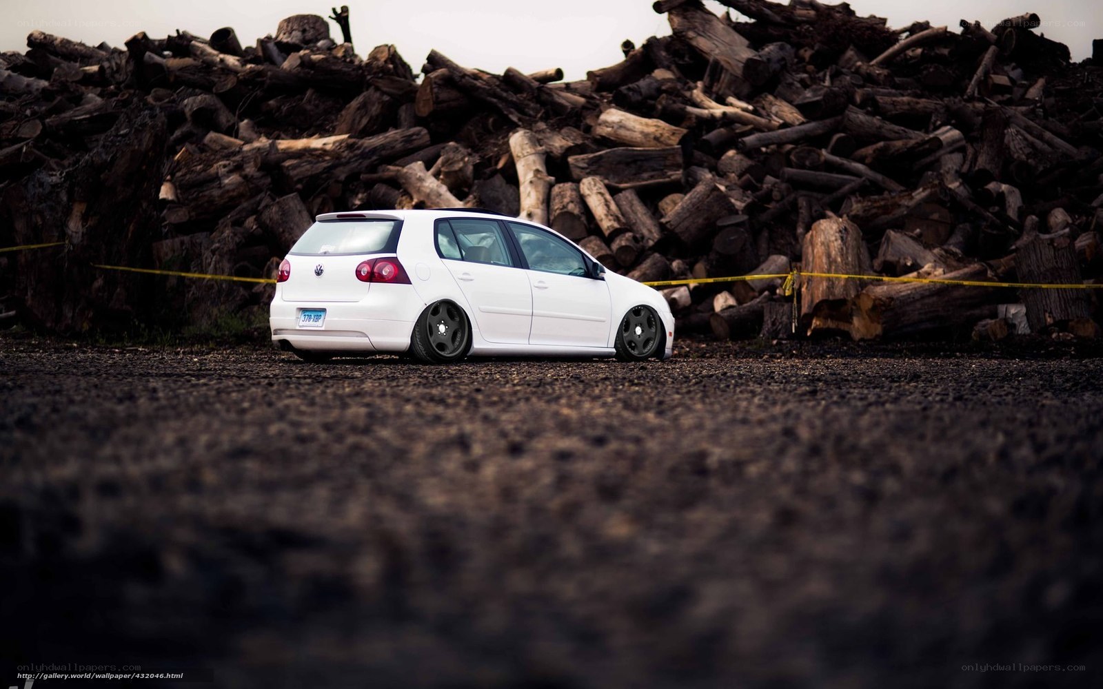 White car in wood pile