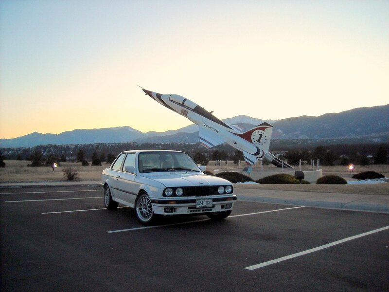 White car near jet sculpture