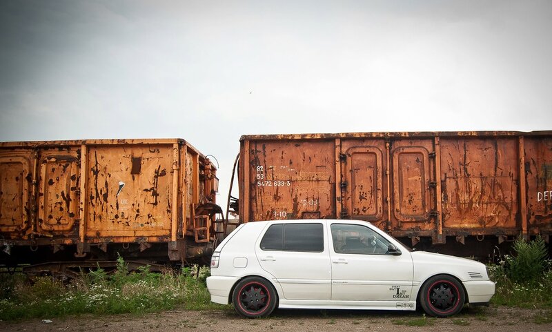 White car near rusty train cars