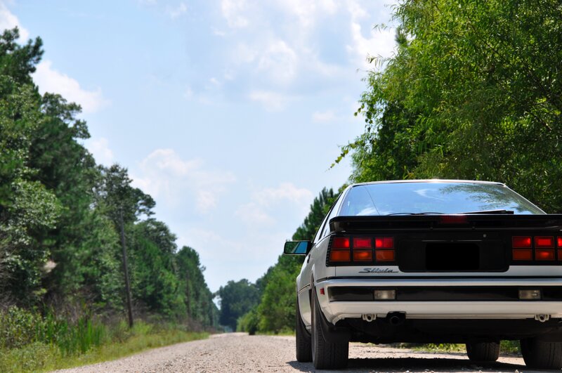 white car on a country road