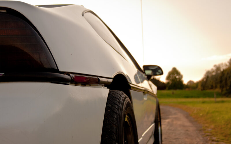 white car on a country road