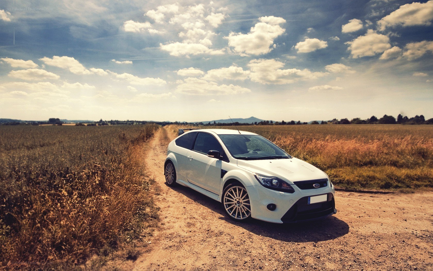 White car on a dirt road