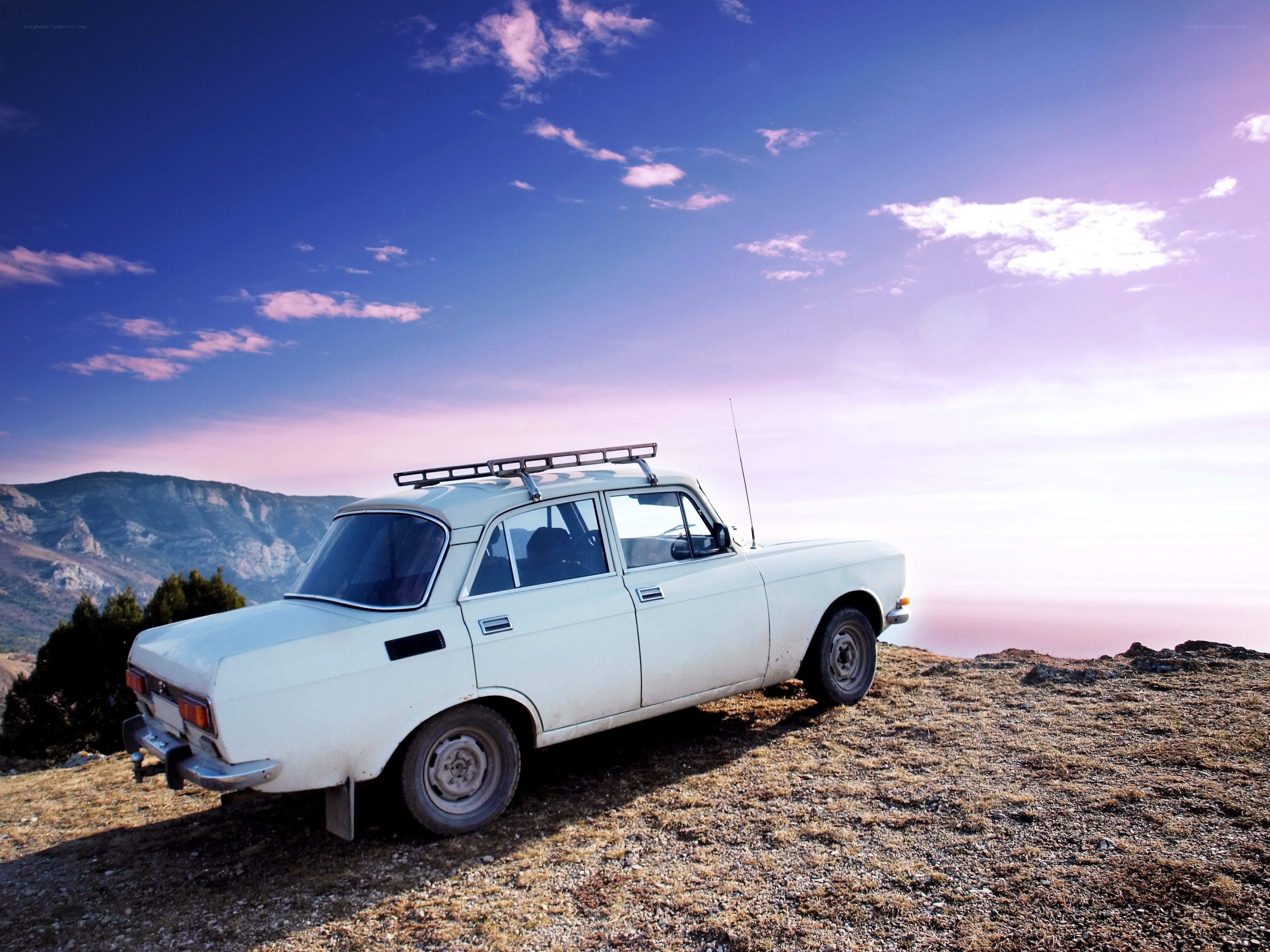 White car on a mountain peak