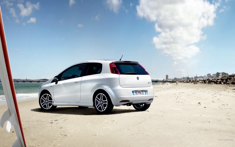 White car on a sunny beach