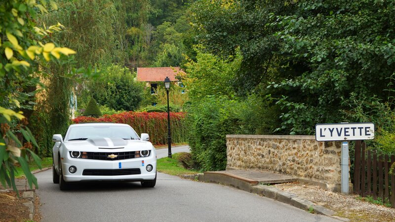 White car on a village road