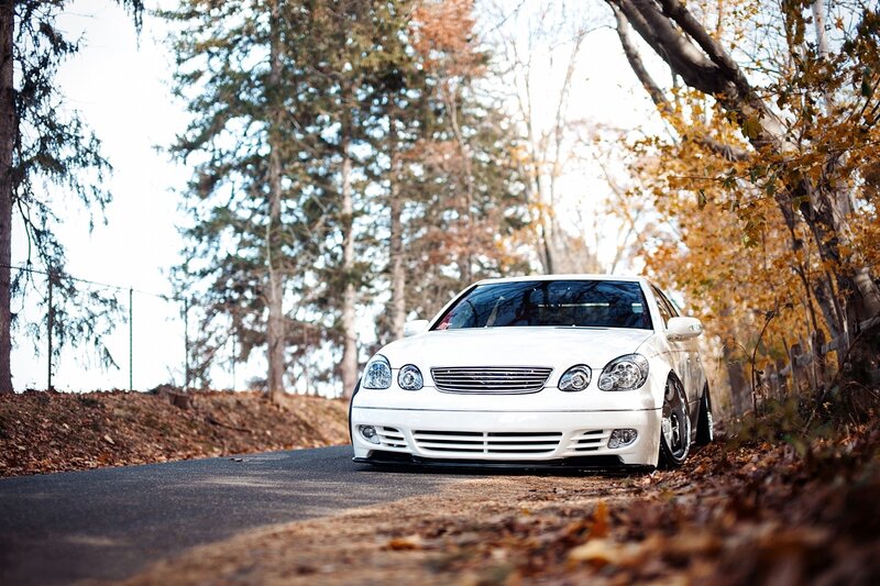 White car on autumn road