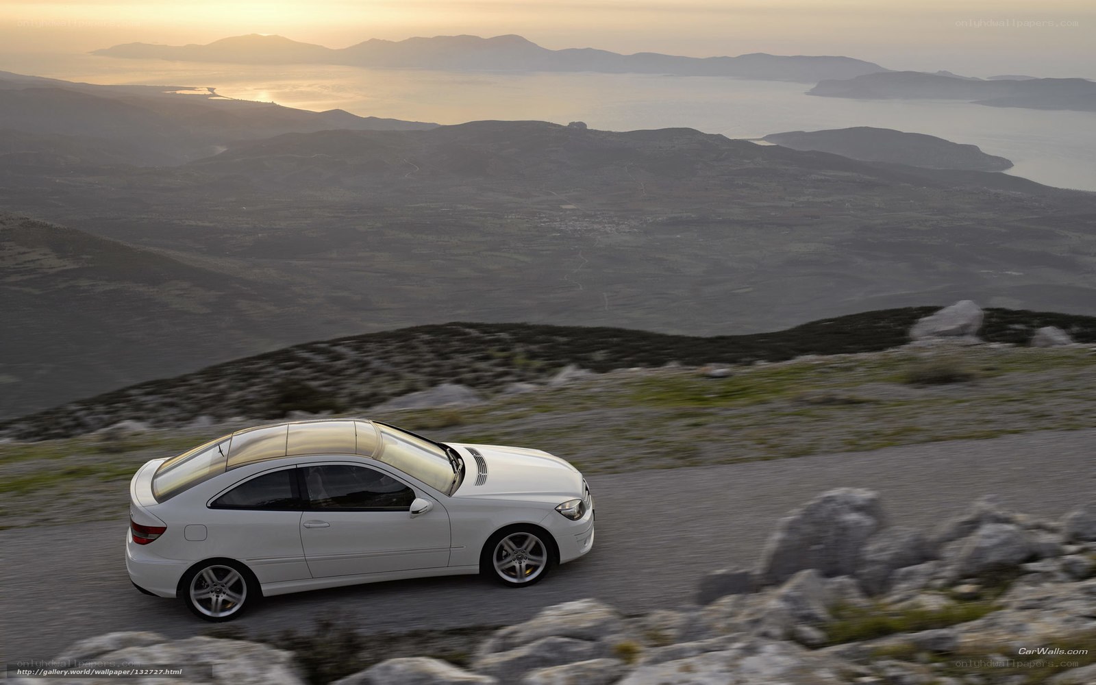 White car on coastal road