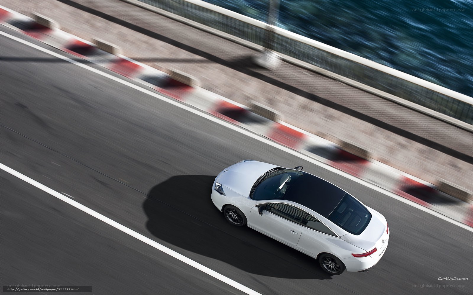 White car on coastal road