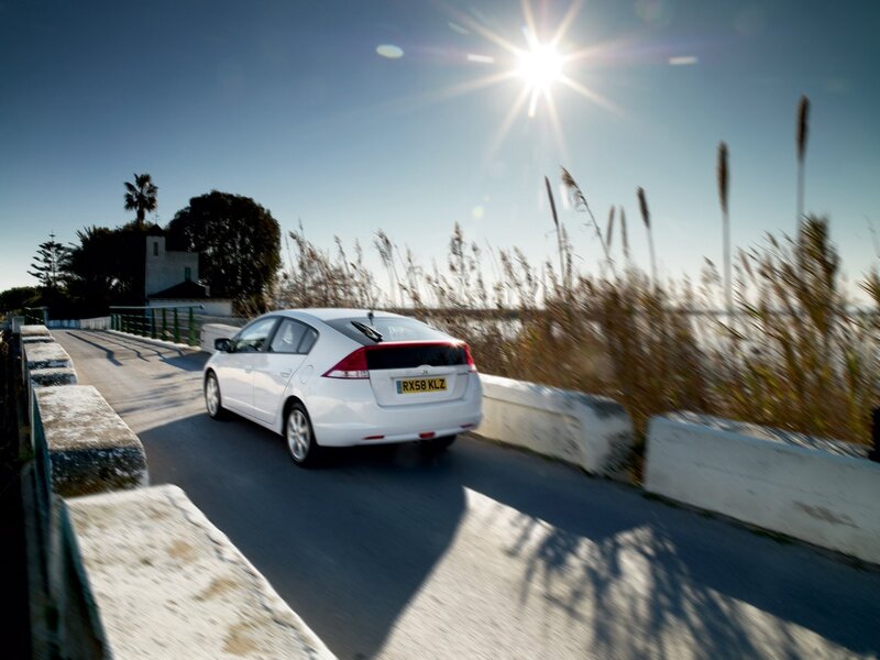 White car on coastal road