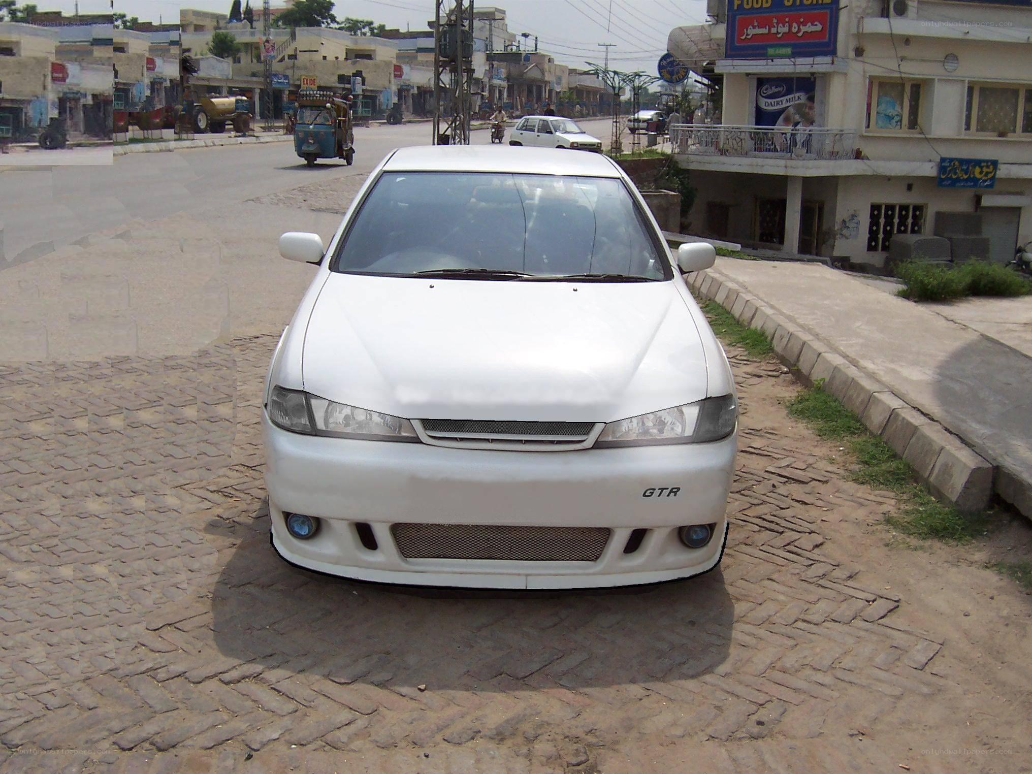white car on cobblestone street