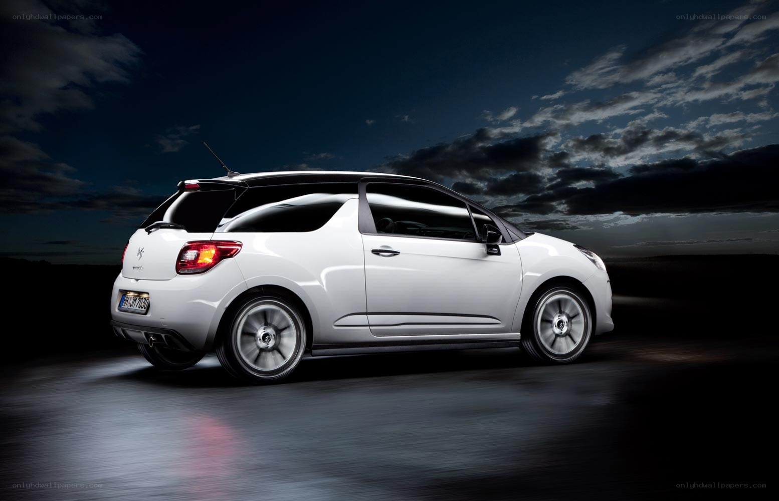 White car on dark road